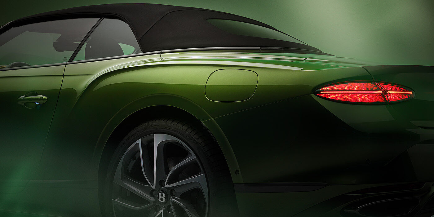 Bentley Berlin Bentley New Continental GTC Speed rear haunch and tail lamp in Tourmaline Green paint and dark tint brightware with black hood up and illuminated head lamps