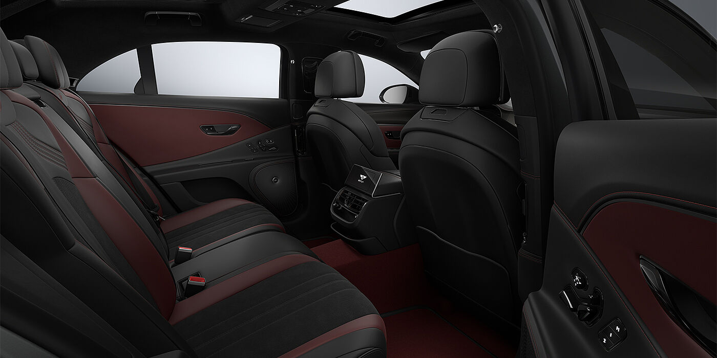 Bentley Berlin New Bentley Flying Spur S sedan rear interior in Cricket Ball red  and Beluga black hides with High Gloss Carbon Fibre veneer