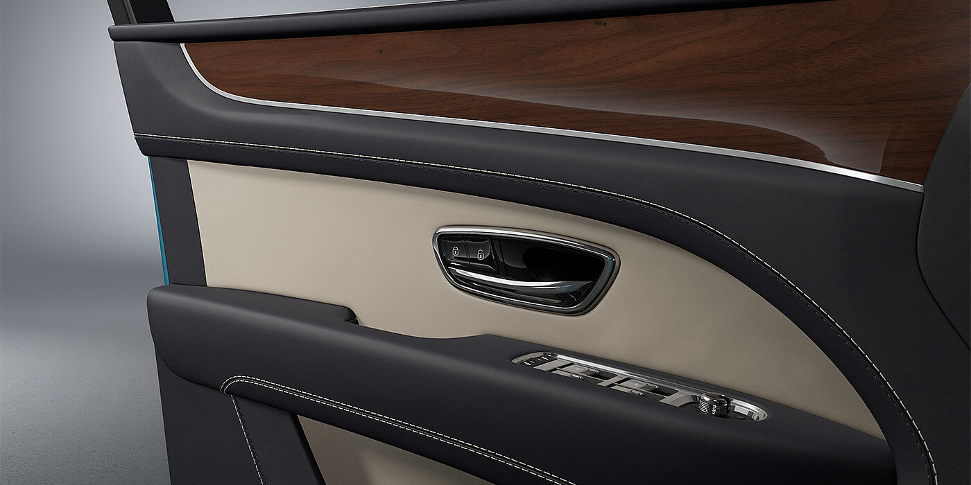 Bentley Berlin Bentley Bentayga EWB SUV door interior detail in Portland and Imperial Blue hides with Crown Cut Walnut veneer