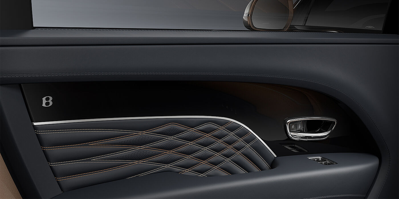 Bentley Berlin Bentley Bentayga EWB Mulliner SUV door interior detail in Brunel hide and Grand Black veneer with Mulliner contrast stitching