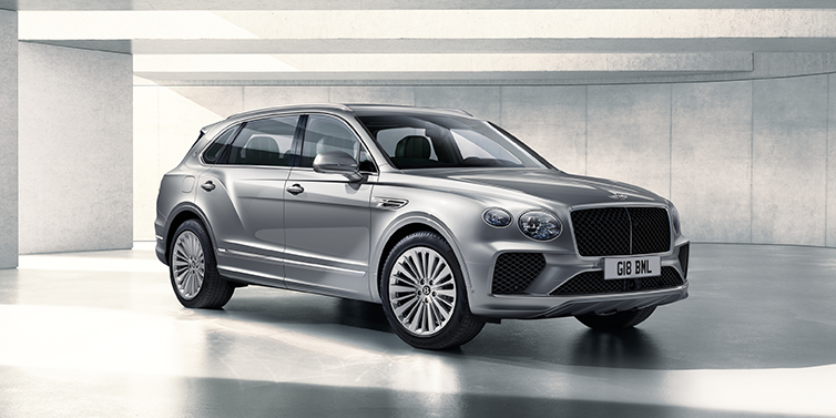Bentley Berlin Bentley Bentayga Extended Wheelbase SUV front three quarter in Moonbeam paint with a grey background
