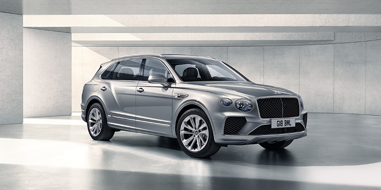 Bentley Berlin Bentley Bentayga Extended Wheelbase SUV front three quarter in Moonbeam paint with a grey background