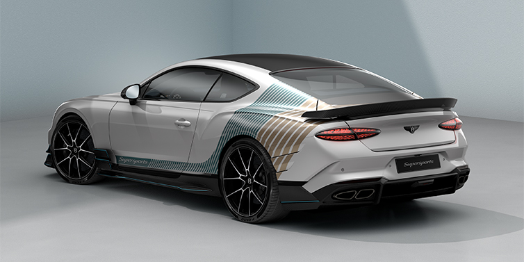 Bentley Berlin Bentley Supersports rear three quarter in "Snowstorm" Design theme with Snow Quartz paint and Topaz blue and Camel brown paint stripes across the rear haunch.