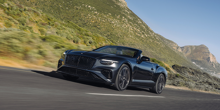 Bentley Berlin Bentley Continental GTC S convertible in Thunder paint front 3/4 driving on mountain road