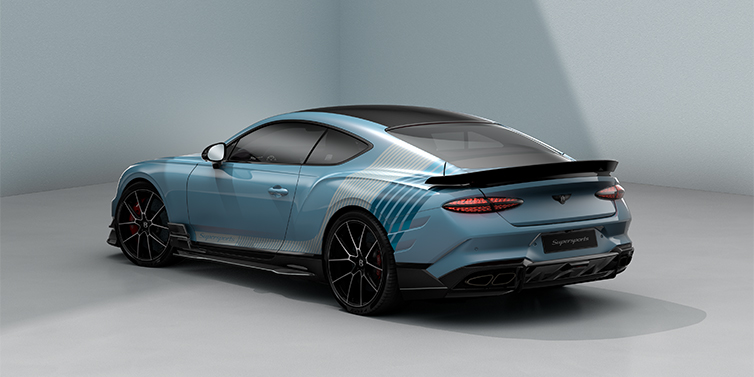 Bentley Berlin Bentley Supersports rear three quarter in "Daybreak" Design theme with Jetstream blue paint and Arctica white and Portofino blue paint stripes across the rear haunch.